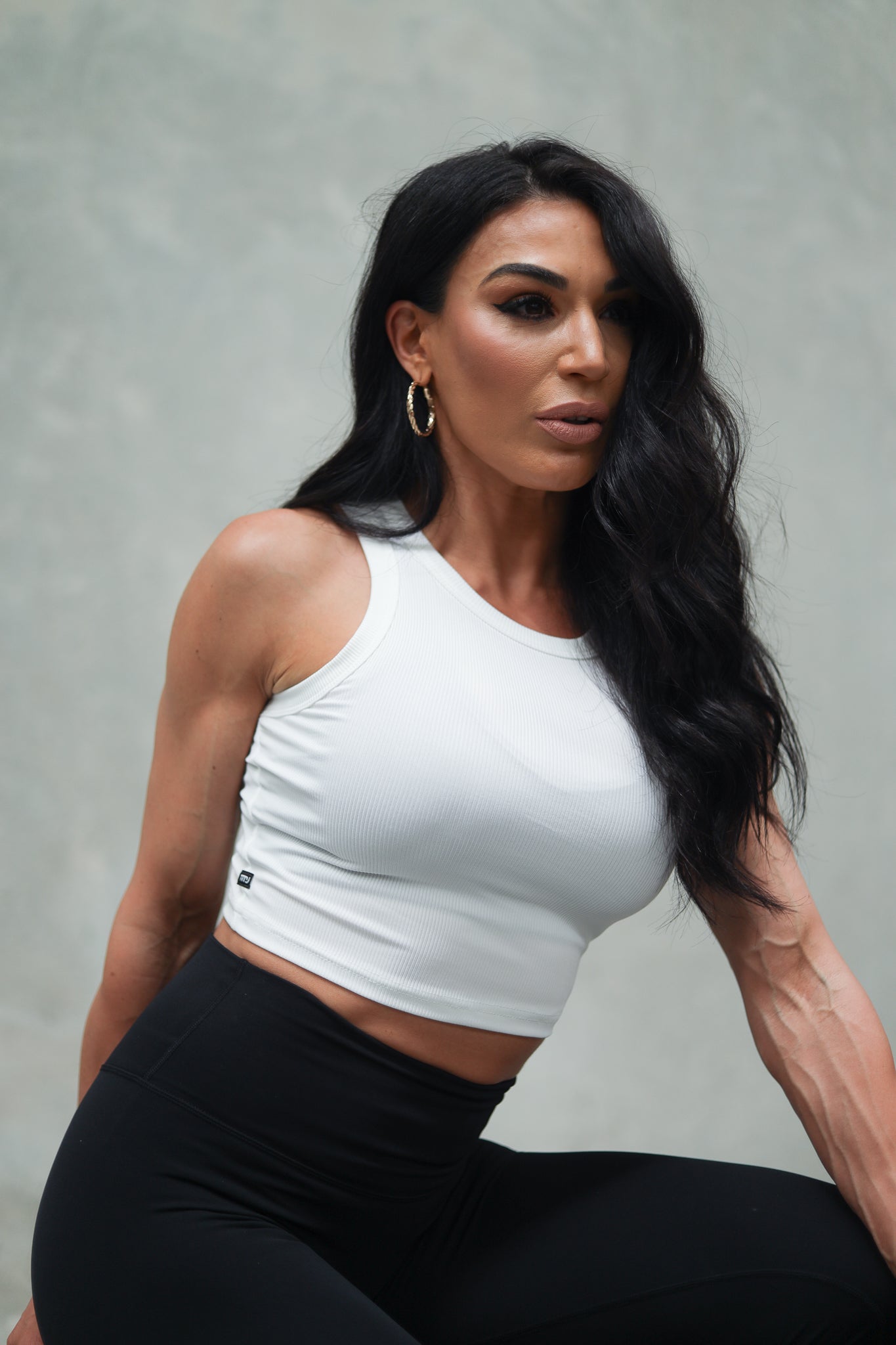 Female wearing white Kendall Rib Tank showing minimal design.