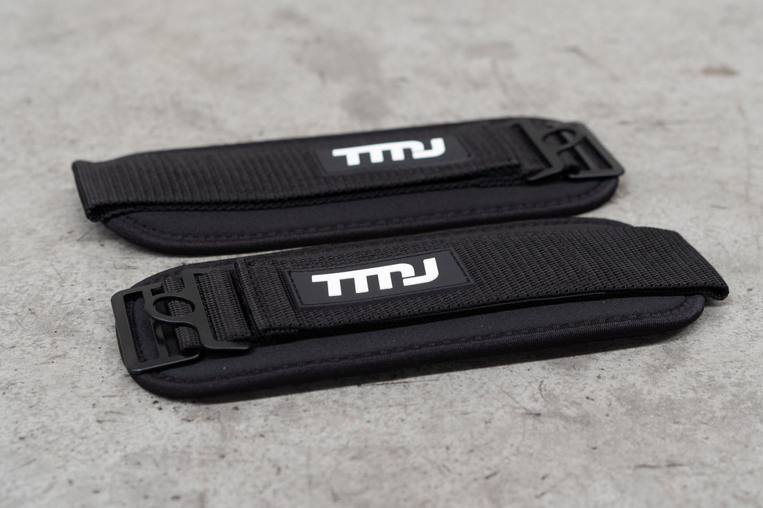 Image of black TMJ Apparel Ankle Straps showing white rubber embossed &quot;TMJ&quot; logo sewn on the front.