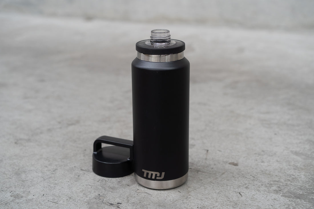 Image of black stainless steel TMJ Apparel 1 litre drink bottle showing gulp cap.
