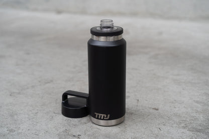 Black stainless steel TMJ Apparel 1 litre drink bottle showing gulp cap.