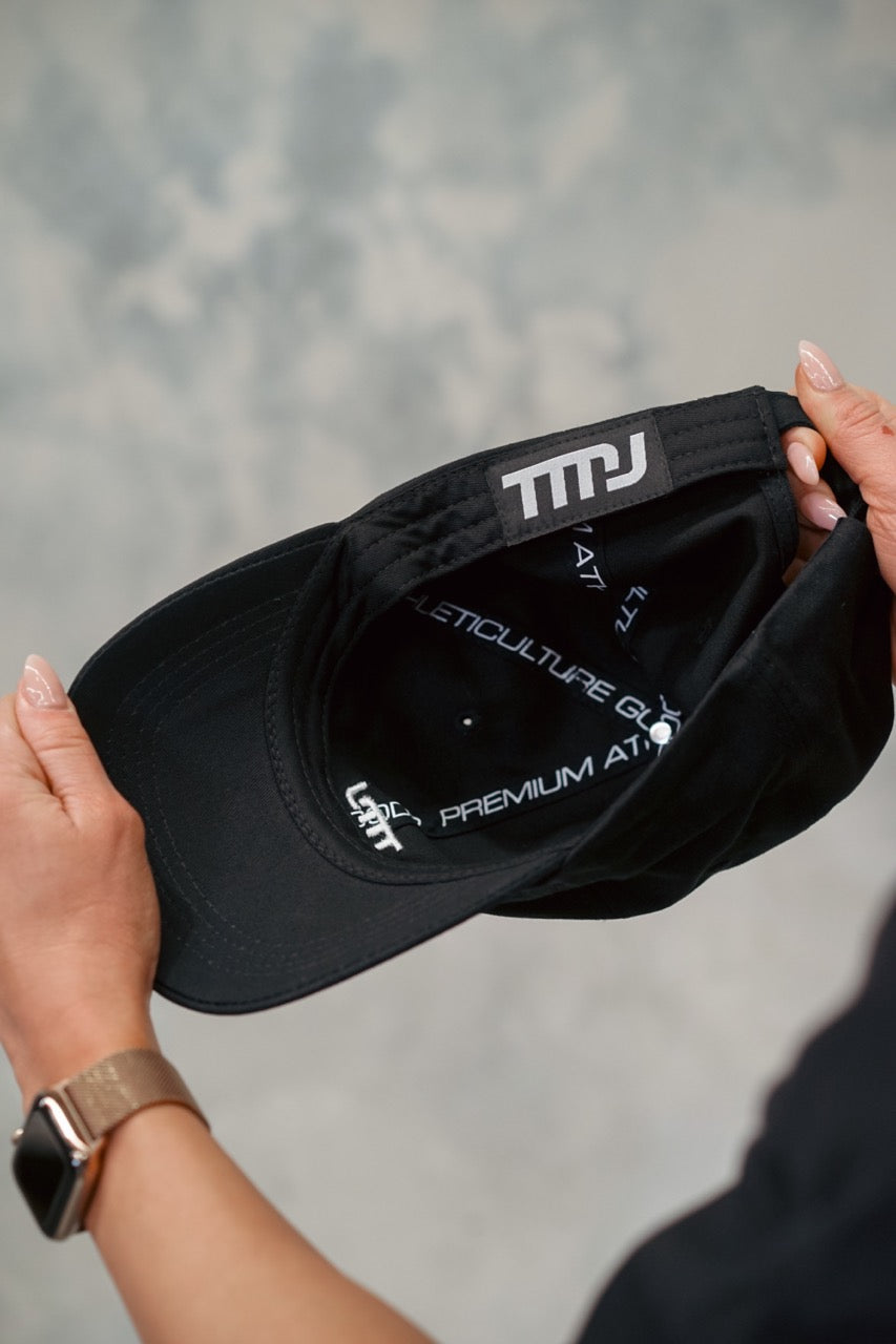 Image of inside of black Chino Cap showing custom TMJ sweatband tag