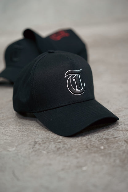 Black TMJ Apparel 9PHIFTY A-Frame Snapback Hat with Black 3D Embroidered Magna Carta T Logo with white outline on the front.